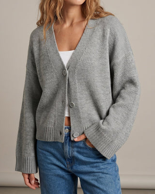 The Lorna knit pullover in beige — front view with hands in pockets on model