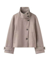 Ottilie Funnel Jacket in taupe, front flat lay on white showing the buttoned funnel collar and cuff tabs