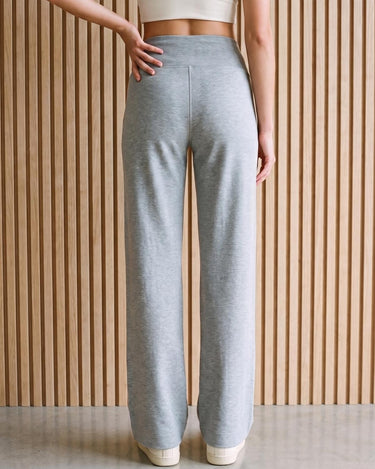 The Rae relaxed pant in light gray — back view on model