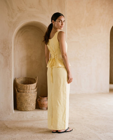 Yellow two-piece set on model, back glance view – Moriel Heritage