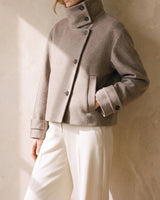 Three-quarter view of the Ottilie Funnel Jacket in taupe with hand in the slit pocket