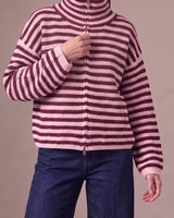 Tori Knit in Burgundy & Pink — worn zipped to the top as a funnel neck