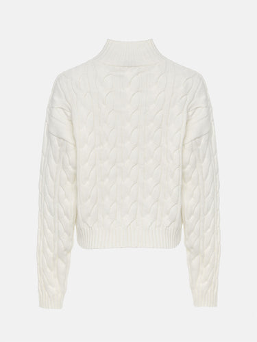 White cable knit sweater on a light beige background
