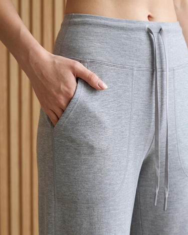 The Rae relaxed pant in light gray — close-up of the drawstring waist and pocket