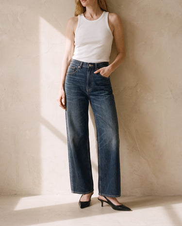 Delphine Wide Leg Jeans in dark vintage wash worn with a white ribbed tank and black slingbacks
