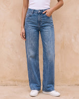 Sloane Straight Leg Jeans in blue — front view with hand in pocket on model