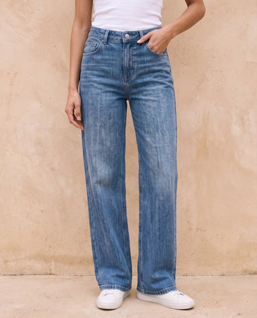 Sloane Straight Leg Jeans in blue — front view with hand in pocket on model