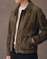 Three-quarter view of the Juniper Suede Utility Jacket with hand in the side pocket