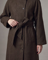 Henrietta Coat in brown, close-up of the self-tie belt, welt pocket and wide cuff