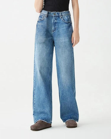 Model in Hallie Jeans and black rib tank, full-length relaxed pose