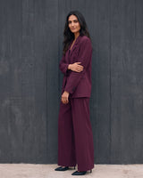 The Aliya Burgundy Blazer Set in burgundy — full suit, side view on model