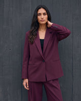 The Aliya Burgundy Blazer Set in burgundy — blazer, side view on model