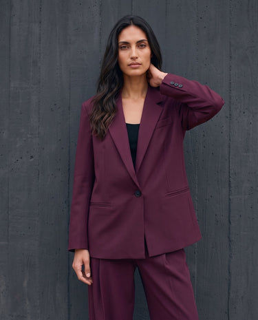 The Aliya Burgundy Blazer Set in burgundy — blazer, side view on model