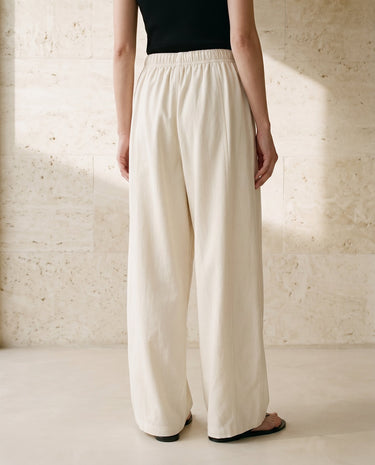Cream wide-fit pants on model, front view – Moriel Heritage