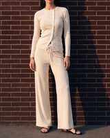 Amarie Set in cream — full-length front view on model against a brick wall