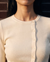 Amarie Set in cream — close-up of the round neck and ribbed button placket