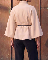 The Aurelia Shawl in beige — back view on model