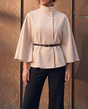 The Aurelia Shawl in beige — front three-quarter view on model