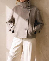 Ottilie Funnel Jacket in taupe worn with both hands in the pockets