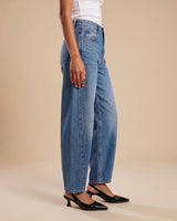 Barrel Jeans in blue — side profile on model showing the rounded barrel leg and tapered hem