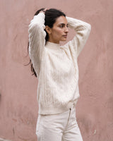 Boat Neck Cable Knit Sweater in white — front three-quarter view on model