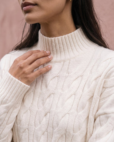 Boat Neck Cable Knit Sweater in white — close-up of the neckline and cable knit detail