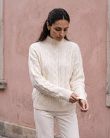 Boat Neck Cable Knit Sweater in white — side view on model