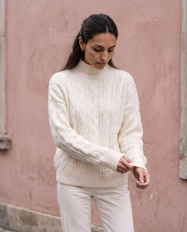 Boat Neck Cable Knit Sweater in white — side view on model