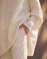 The Lorna Collared Knit in ivory — close-up of the ribbed cuff, hem band and pointed hem