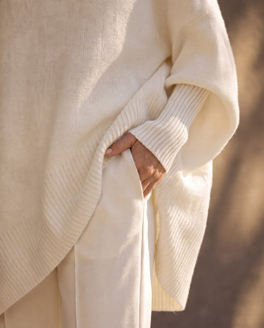 The Lorna Collared Knit in ivory — close-up of the ribbed cuff, hem band and pointed hem