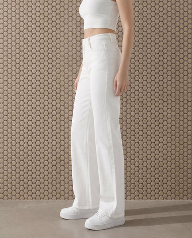 Three-quarter front view of the white Cali Jean showing the high waistband, belt loops and the wide leg falling straight to the floor