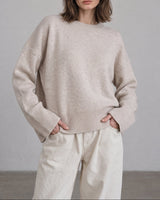 Beige Cali Knit on model — relaxed crew-neck sweater with white trousers, front view – Moriel Heritage