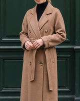 The Calvera double-breasted wool coat in khaki — front view on model