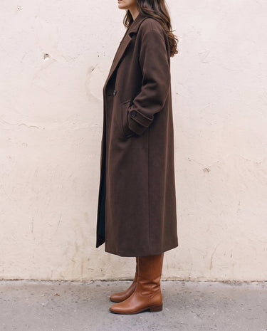 The Chocolate Maxi Coat in chocolate brown — longline coat, side view on model