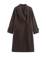 The Chocolate Maxi Coat in chocolate brown — double-breasted longline coat with lapel collar and patch pockets, product flat-lay