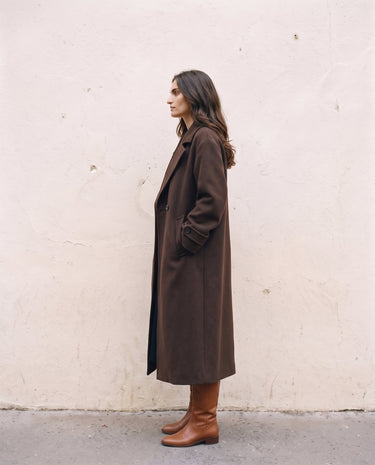 The Chocolate Maxi Coat in chocolate brown — longline coat, side view on model
