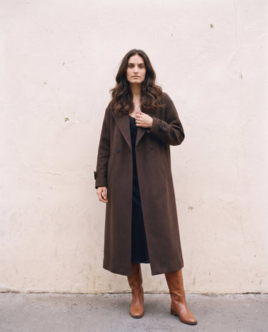 The Chocolate Maxi Coat in chocolate brown — longline coat worn open, front view on model