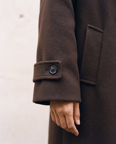 The Chocolate Maxi Coat in chocolate brown — close-up of the buttoned cuff and pocket