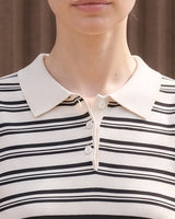 Cosetta Polo in white — close-up of the cream collar and three-button placket