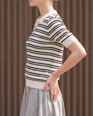 Cosetta Polo in white — side view on model showing the fitted shape
