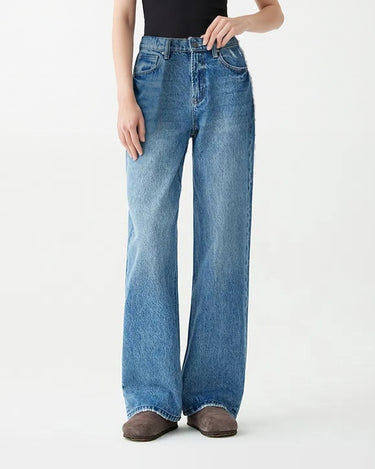 Model wearing Hallie Jeans with a black tank, hand resting on the front pocket