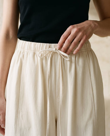 Cream wide-fit pants, drawstring tie waist close-up – Moriel Heritage