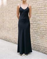 Straight-on front view of the black Eclipse Satin Dress showing the full length of the slip silhouette