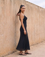 The Elowen Polka Dot Dress in black polka dot — slip maxi dress, side view on model