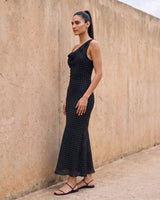 The Elowen Polka Dot Dress in black polka dot — slip maxi dress, side view on model