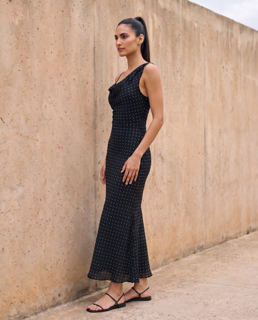 The Elowen Polka Dot Dress in black polka dot — slip maxi dress, side view on model