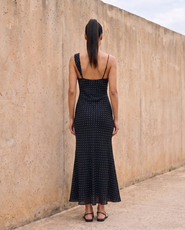The Elowen Polka Dot Dress in black polka dot — slip maxi dress, back view on model