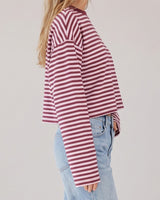 Everyday Stripe in burgundy and pink — side profile on model showing the boxy cut and long sleeve