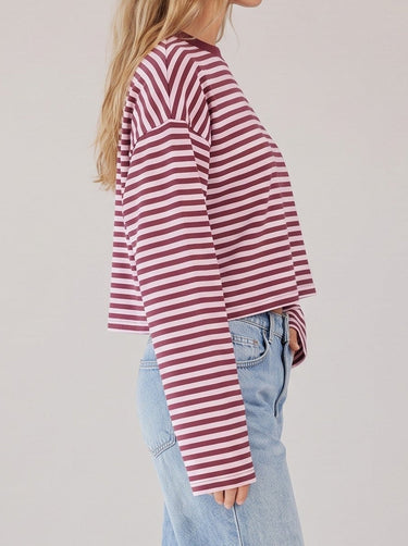 Everyday Stripe in burgundy and pink — side profile on model showing the boxy cut and long sleeve