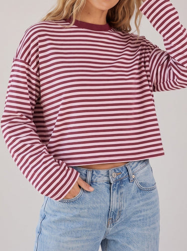 Everyday Stripe in burgundy and pink — waist-up three-quarter view on model, hand in pocket